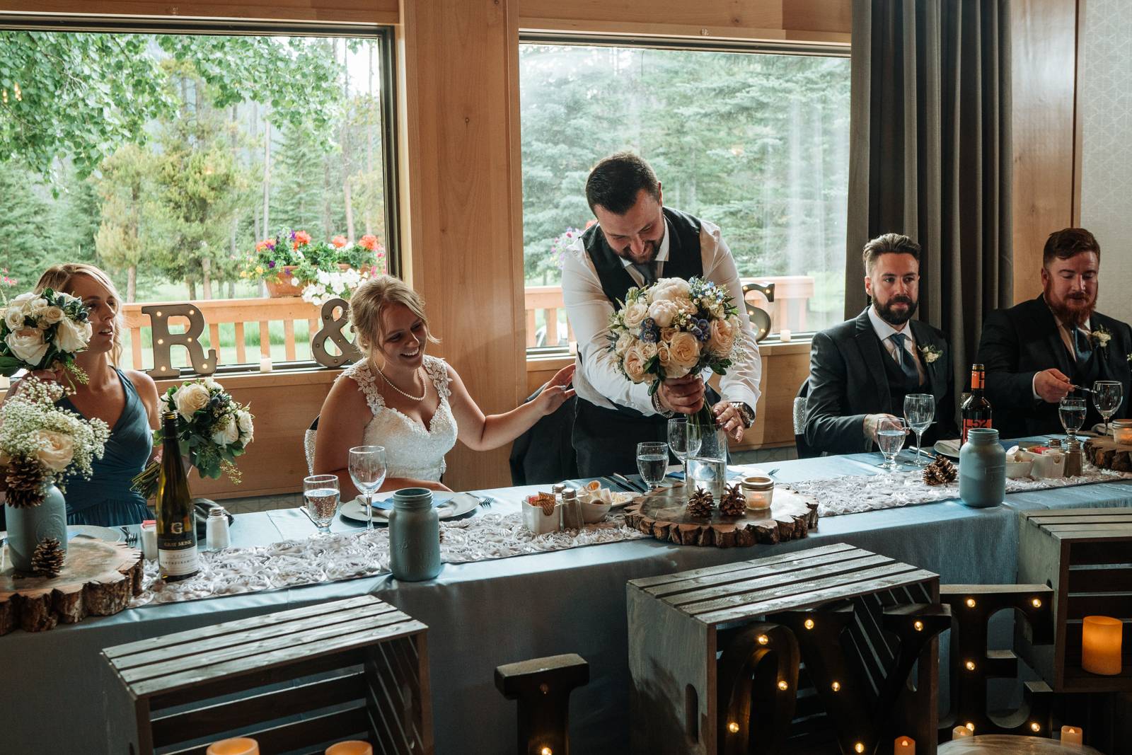 groom puts wedding flowers to the water