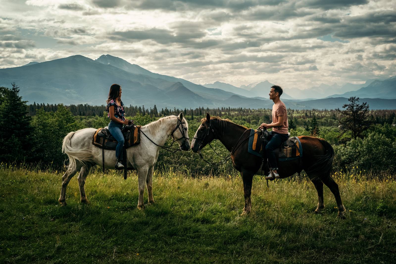 engaged-couple-sitting-on-the-horses