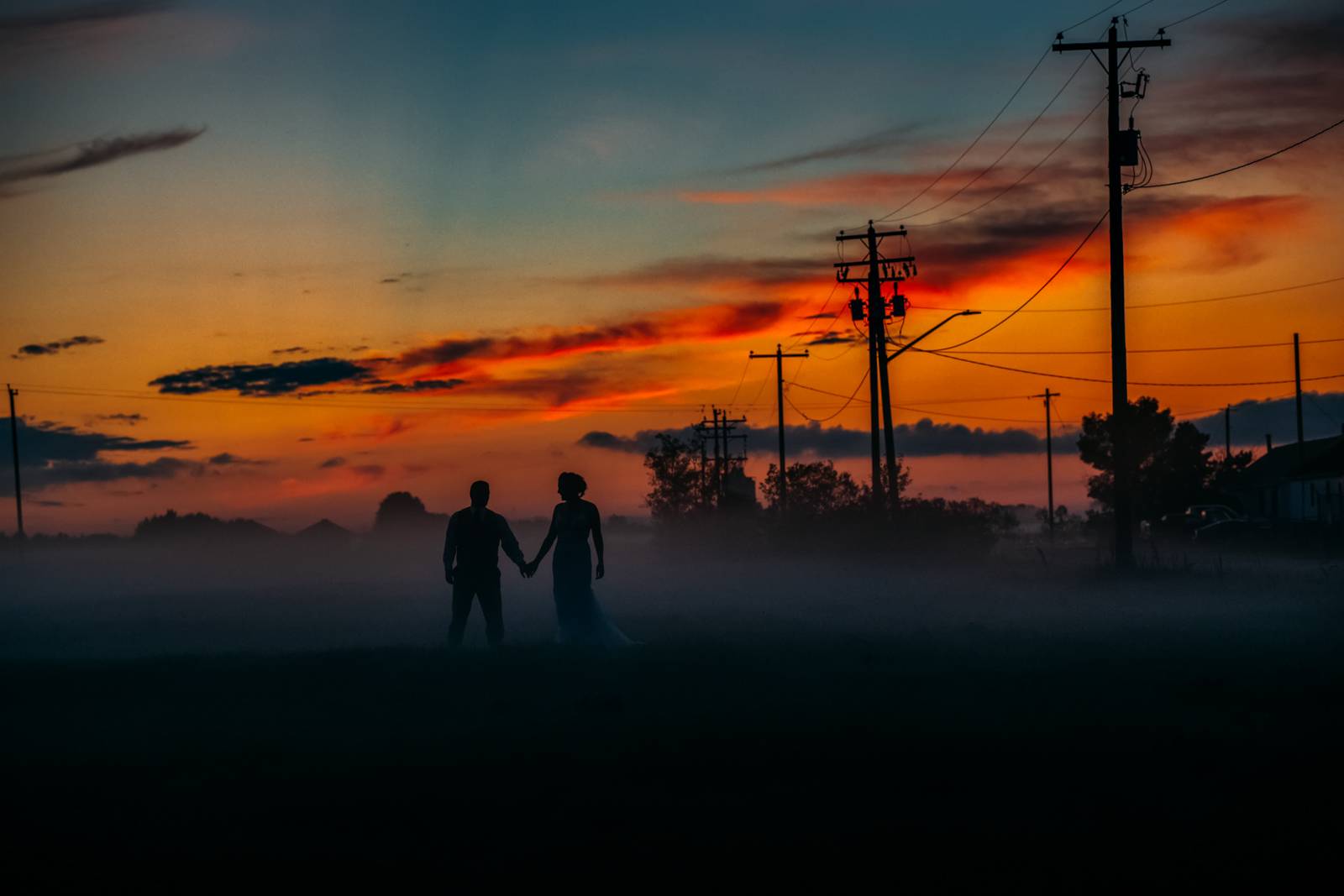 sunset portrait of bride and groom in the foggy evening