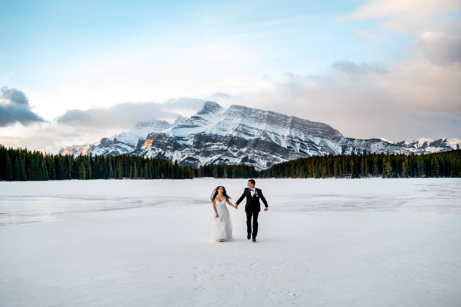 elopement couple holding their  hands and running