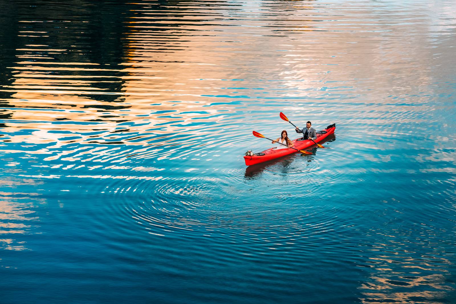 bride and groom kayaking