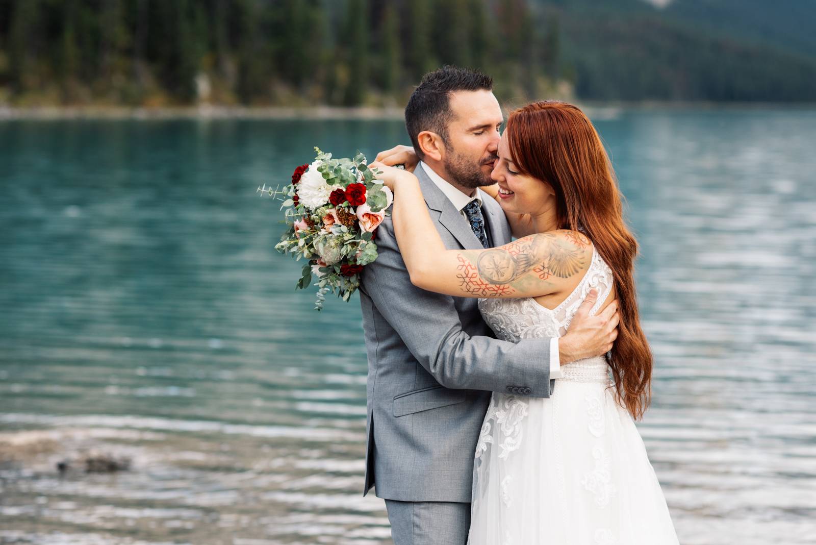 groom kisses bride in the cheek