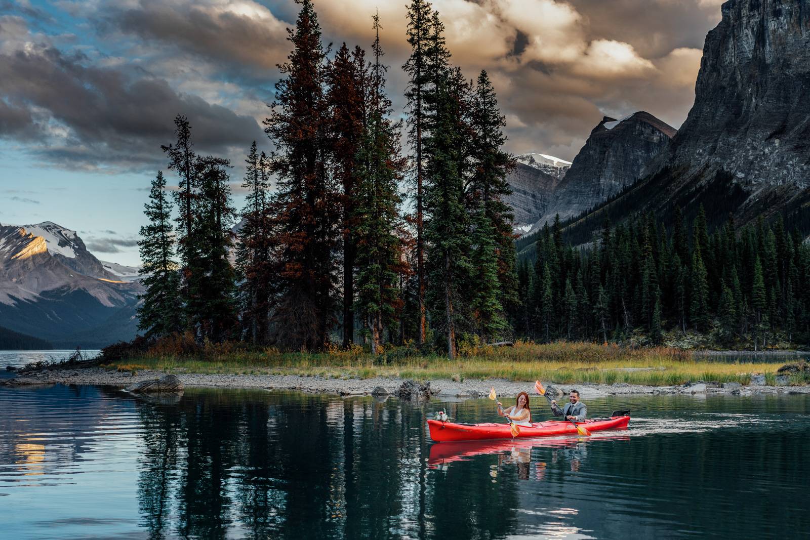 elopement couple sitting in the red kayak