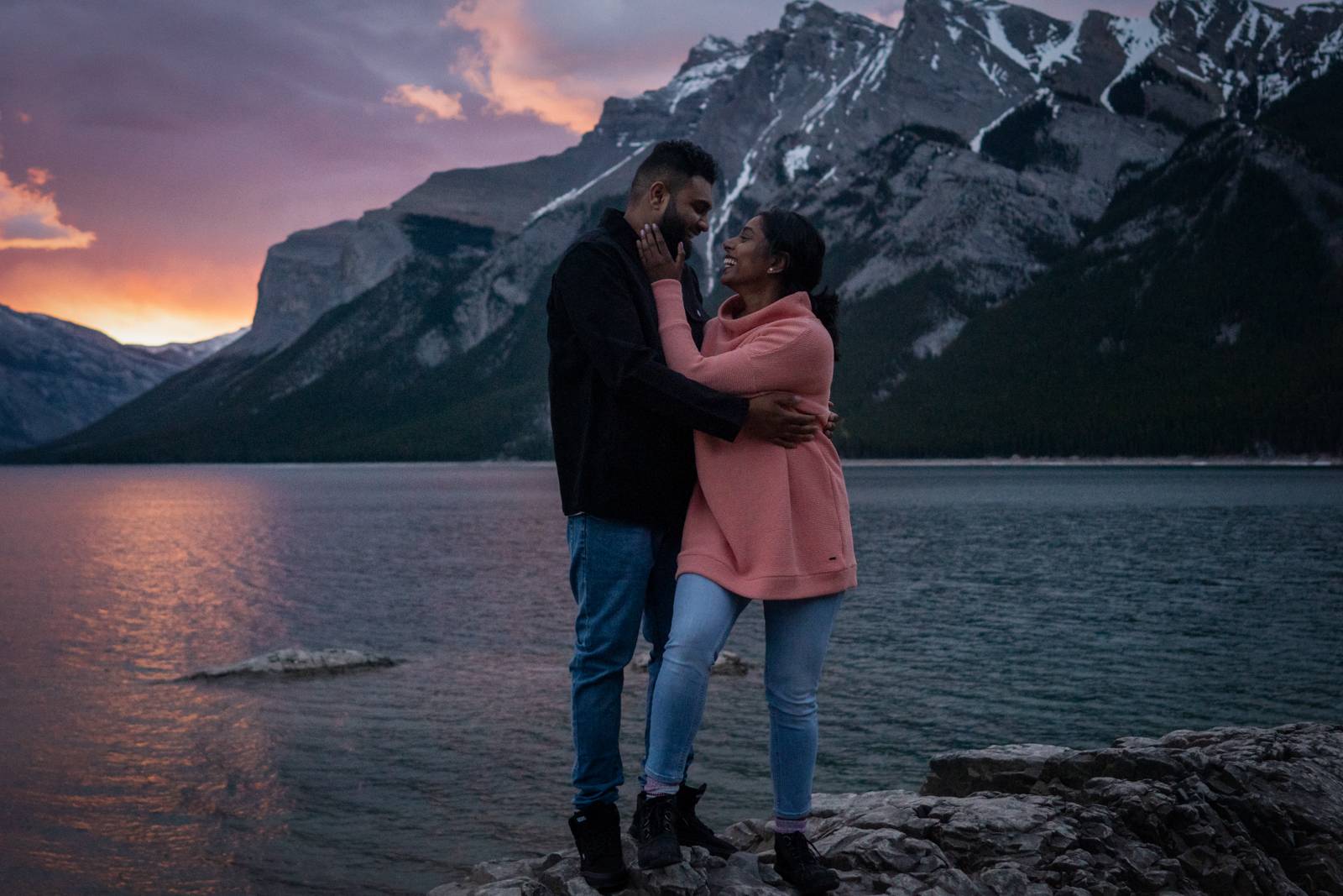 couple hugging at lake minnewanka