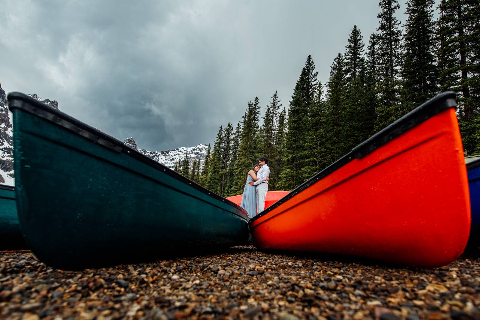couple hugging between two canoes