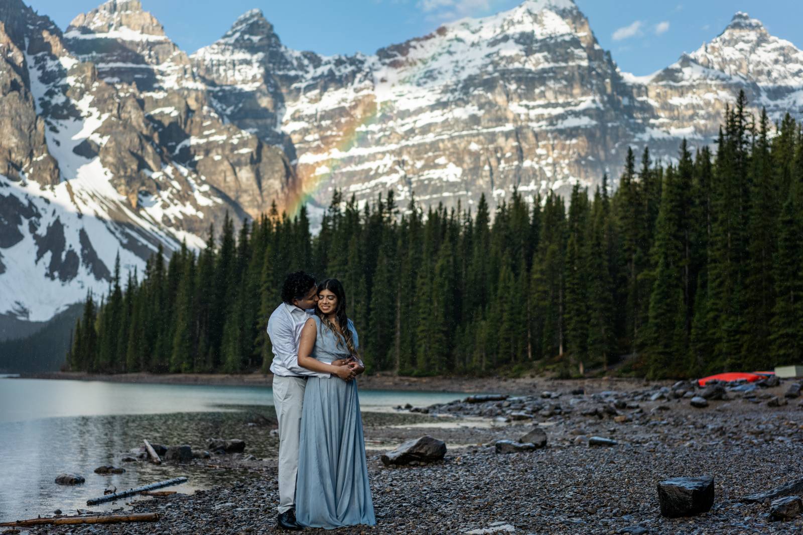 couple kissing and rainbow at moraine lake