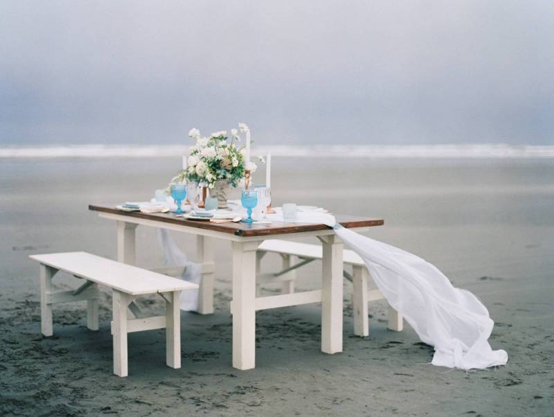 farm table, beach, beach wedding, organic, rustic, white linen, blue glasses, white benches, white w