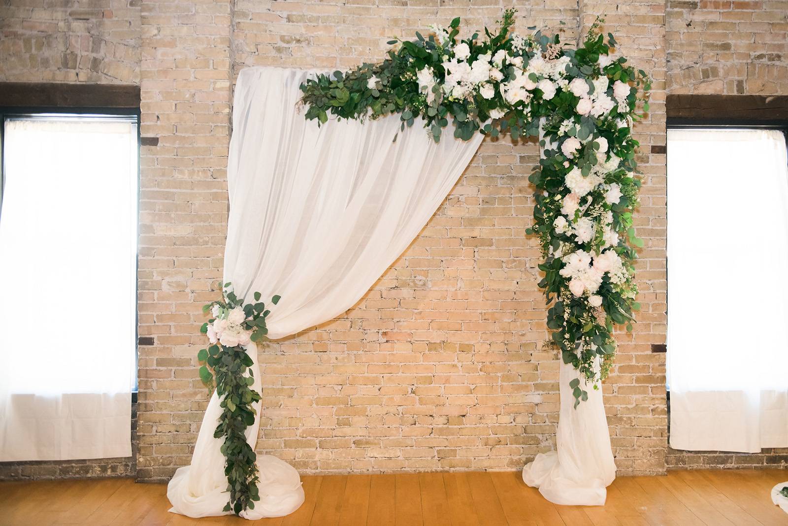 ceremony arch arbor draping flowers floral blooms