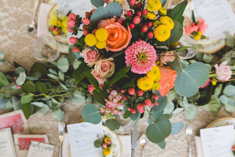 wedding table floral centerpieces yellow pink blush orange peach flowers floral blooms