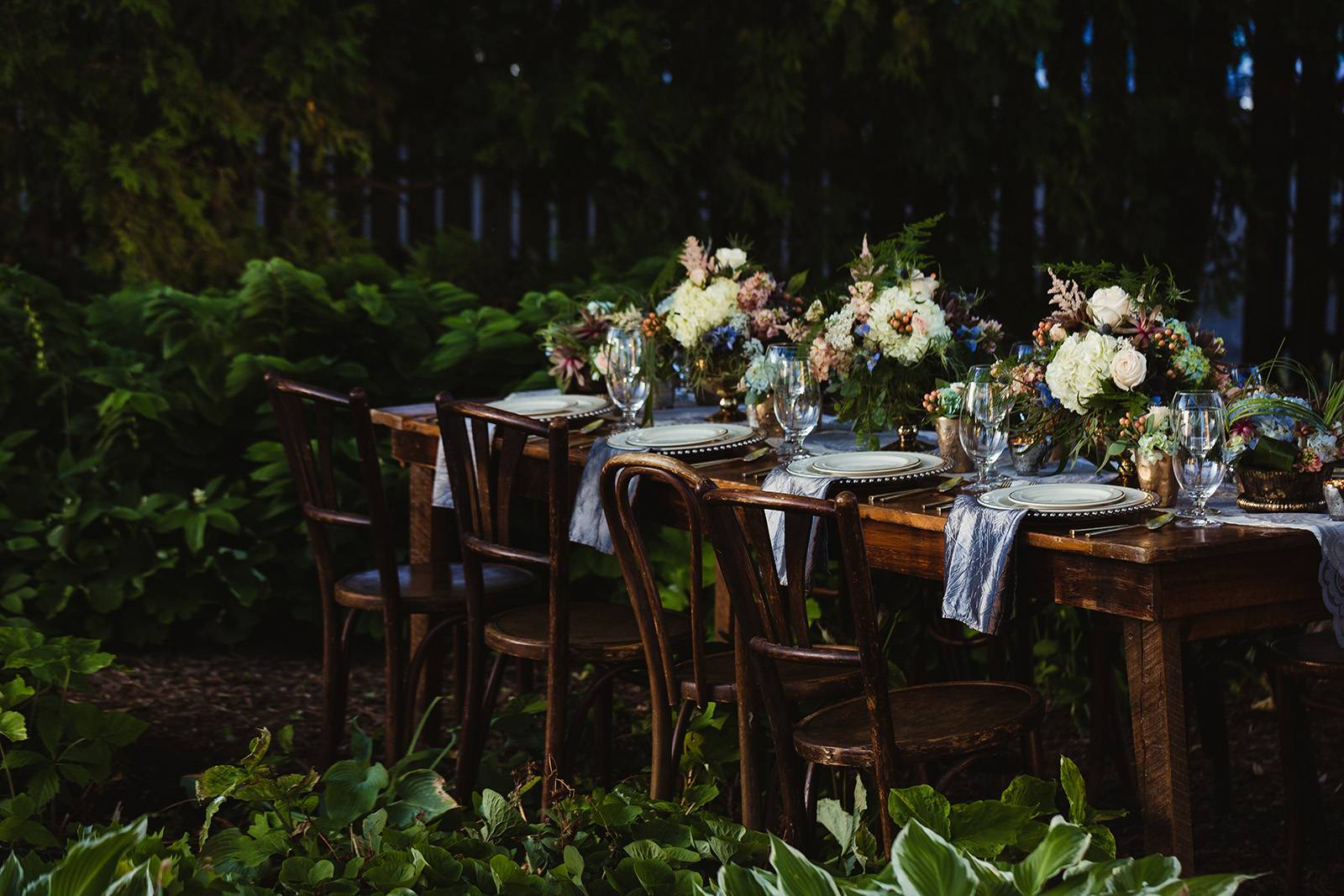 wedding dinner table reception ideas harvest table vintage wood chairs centerpieces forest fairytale