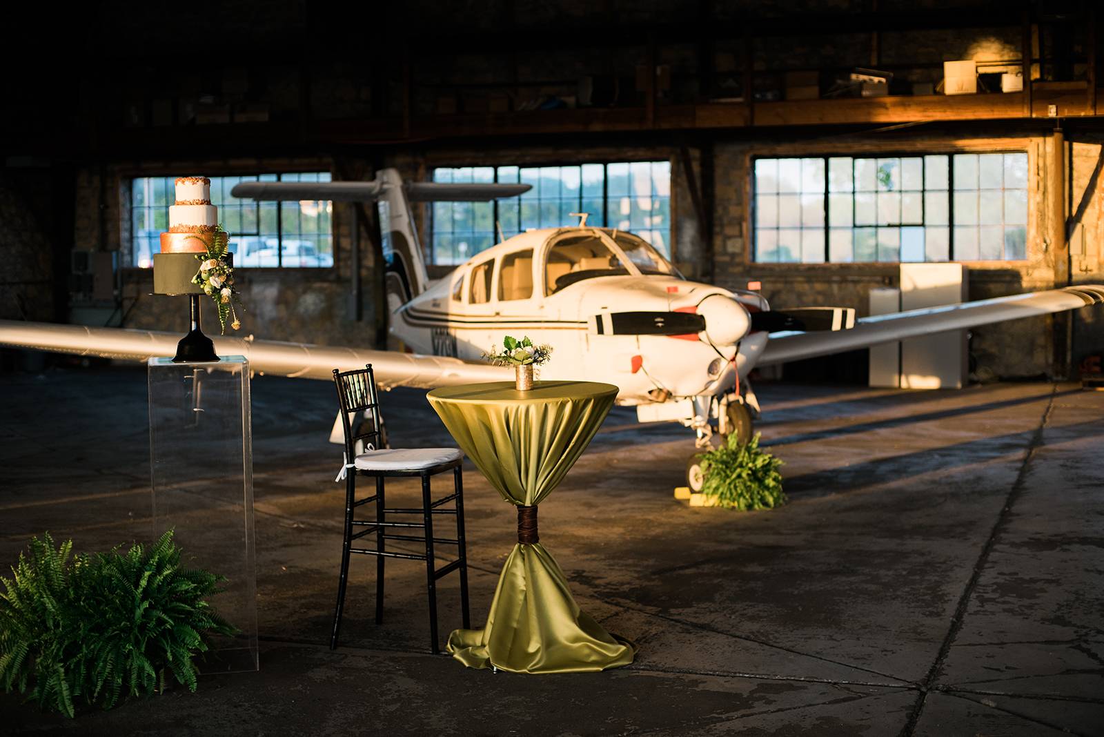 airplane hangar wedding reception venue space, green cocktail tables, cocktail hour, cocktail recept