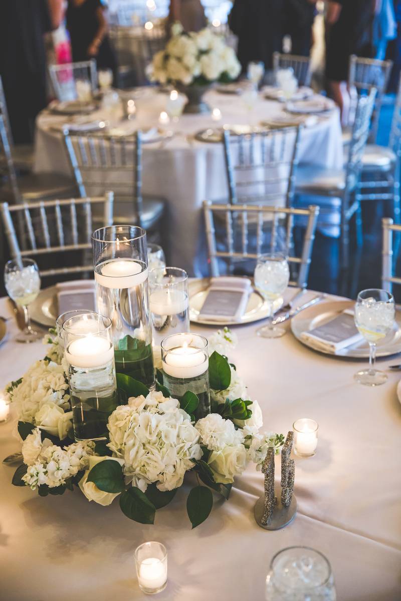 white centerpieces, silver chivari reception chairs, hydrangea centerpieces flowers