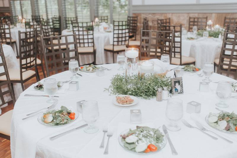 white wedding reception table, candles, greenery centerpieces