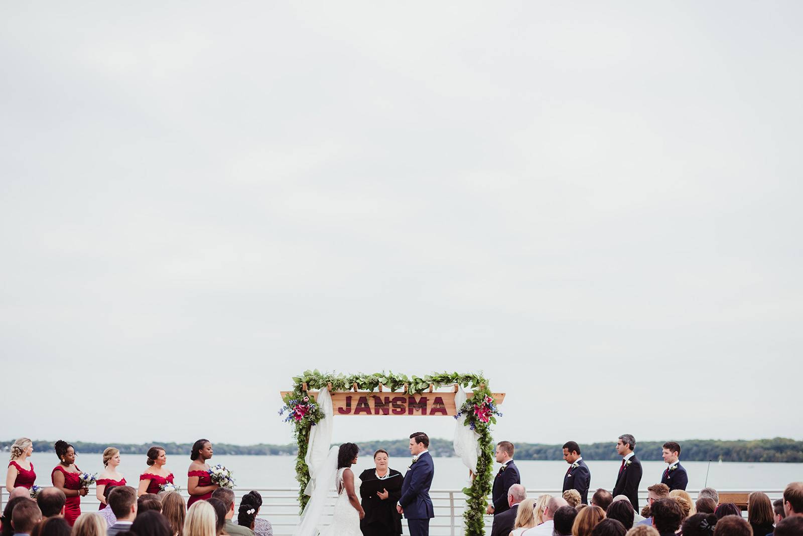 outdoor lake ceremony arch flowers floral