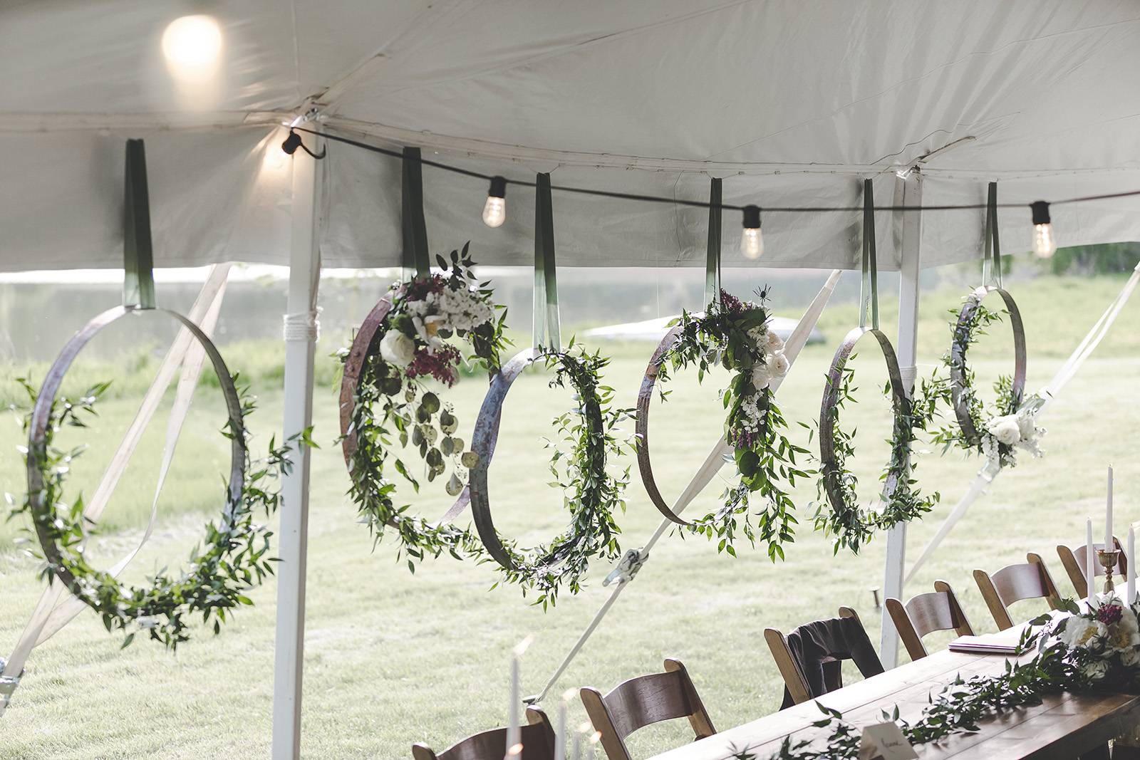 hanging florals, floral flower hoops, arches, reception flowers, outdoor tent wedding decor
