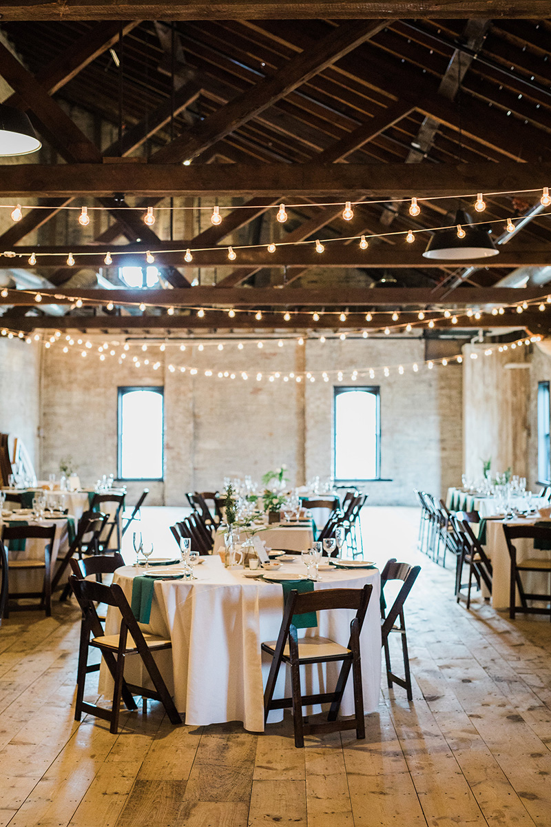 simple minimal greenery industrial warehouse wedding reception, cafe lighting