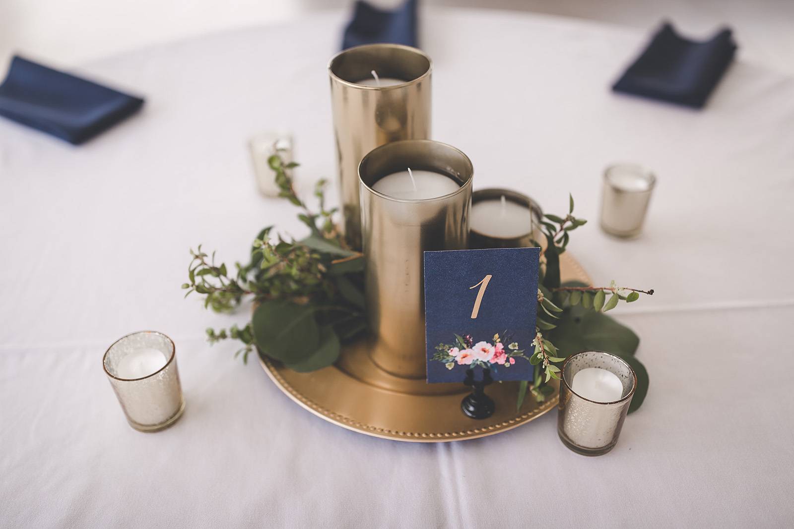 gold navy blue candle greenery centerpieces