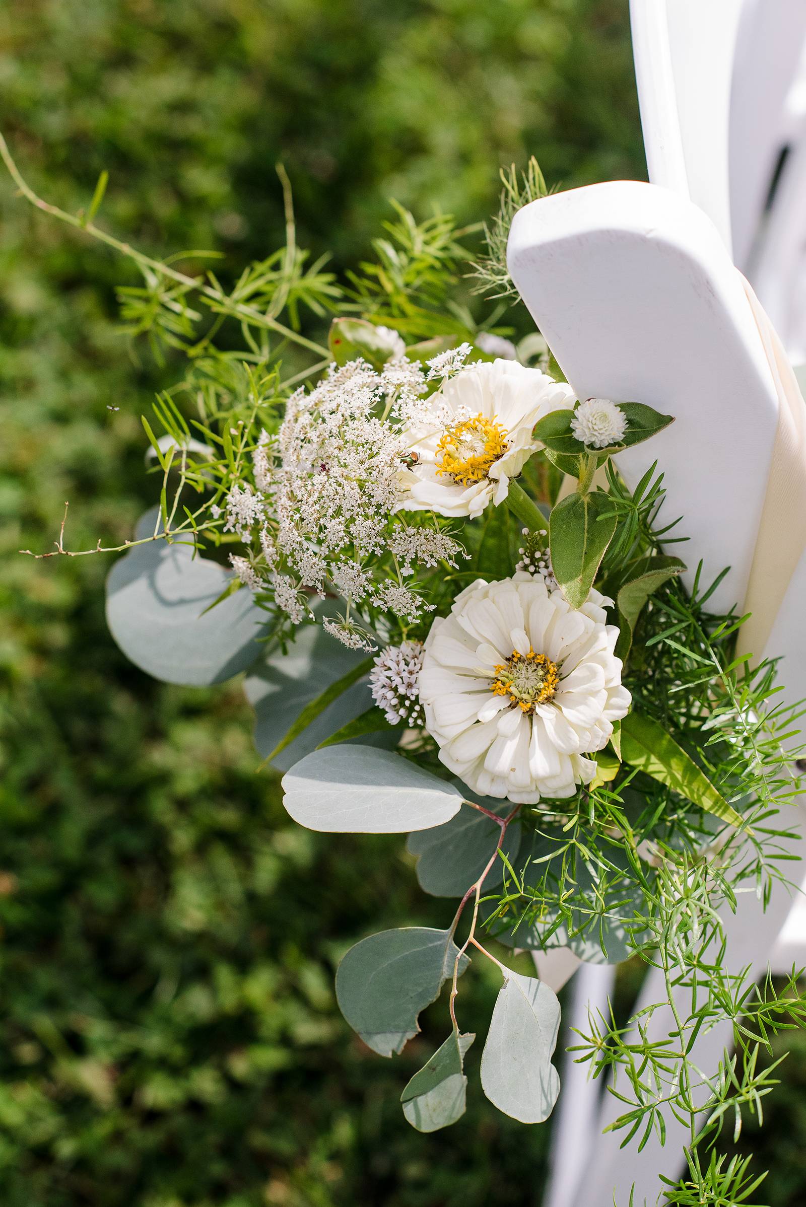 white wildflowers chair floral, ceremony flowers