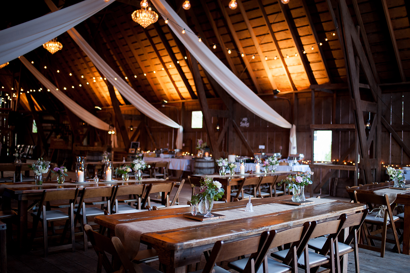 indoor barn wedding reception farm tables