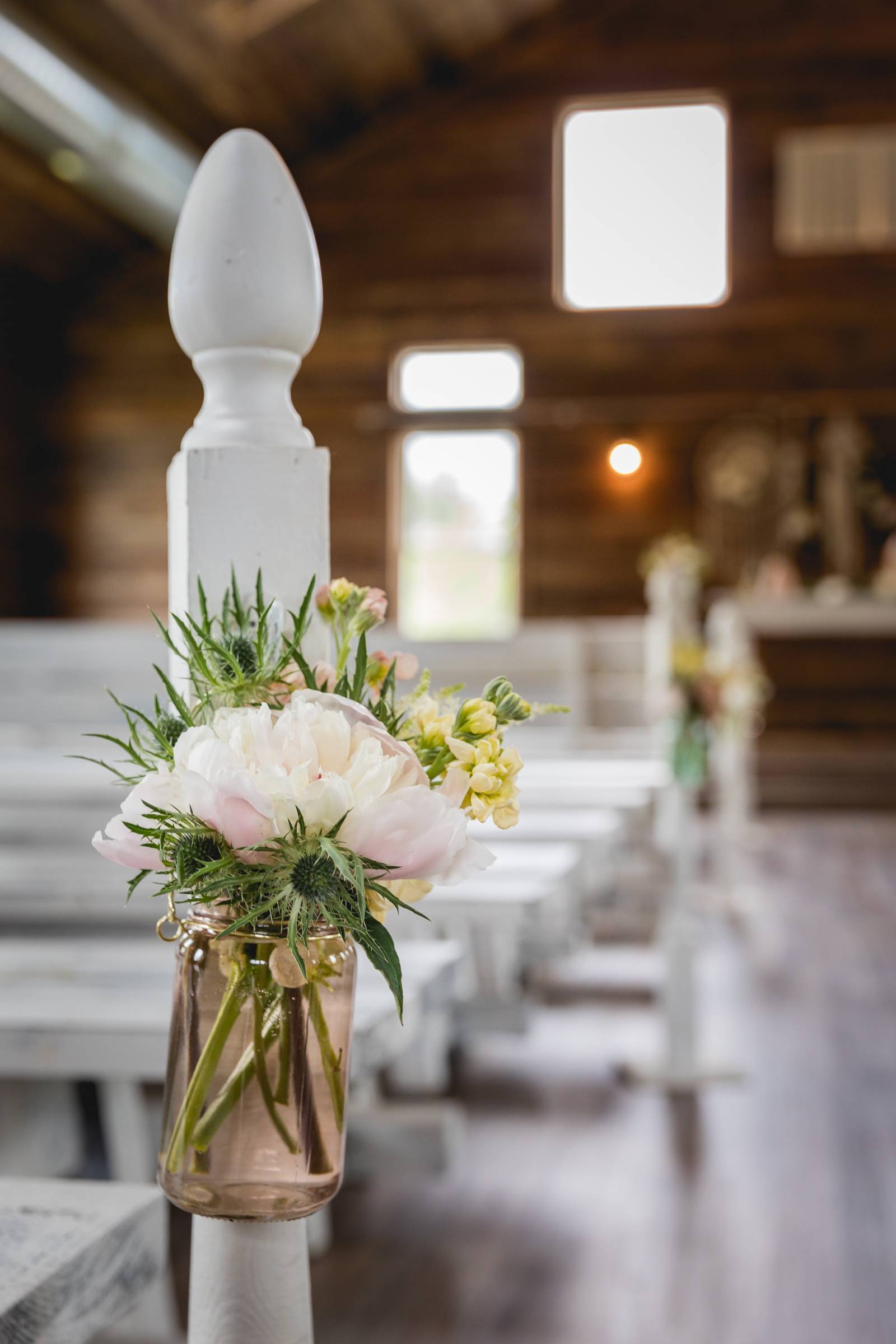 barn wedding ceremony pew chair side floral