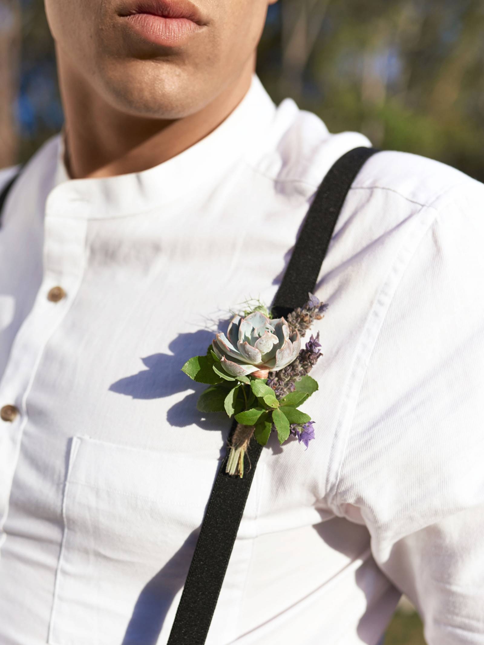 Groom in white linen shirt with band collar and succulent boutonniere