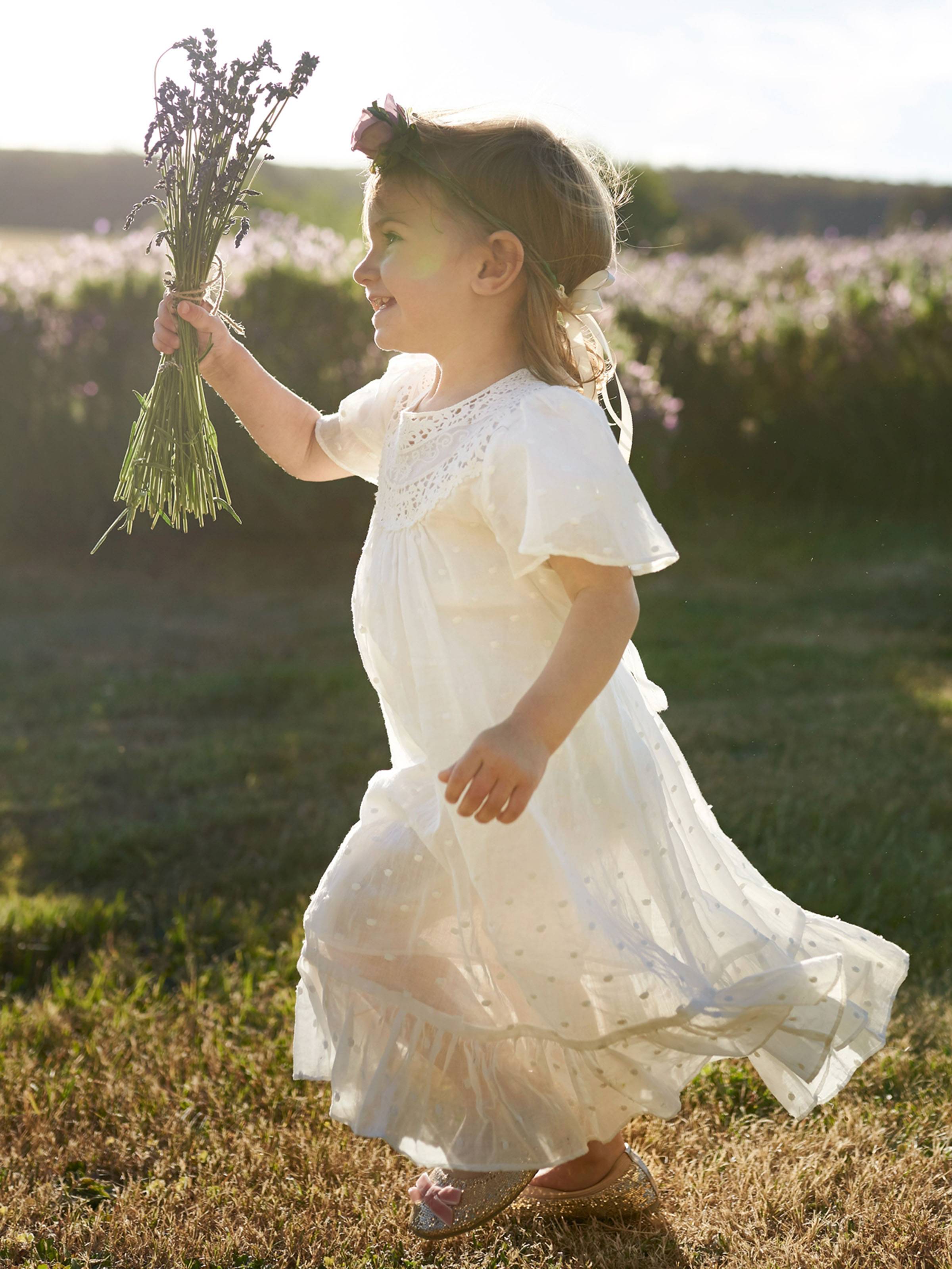 Flower girl running through a lavender field