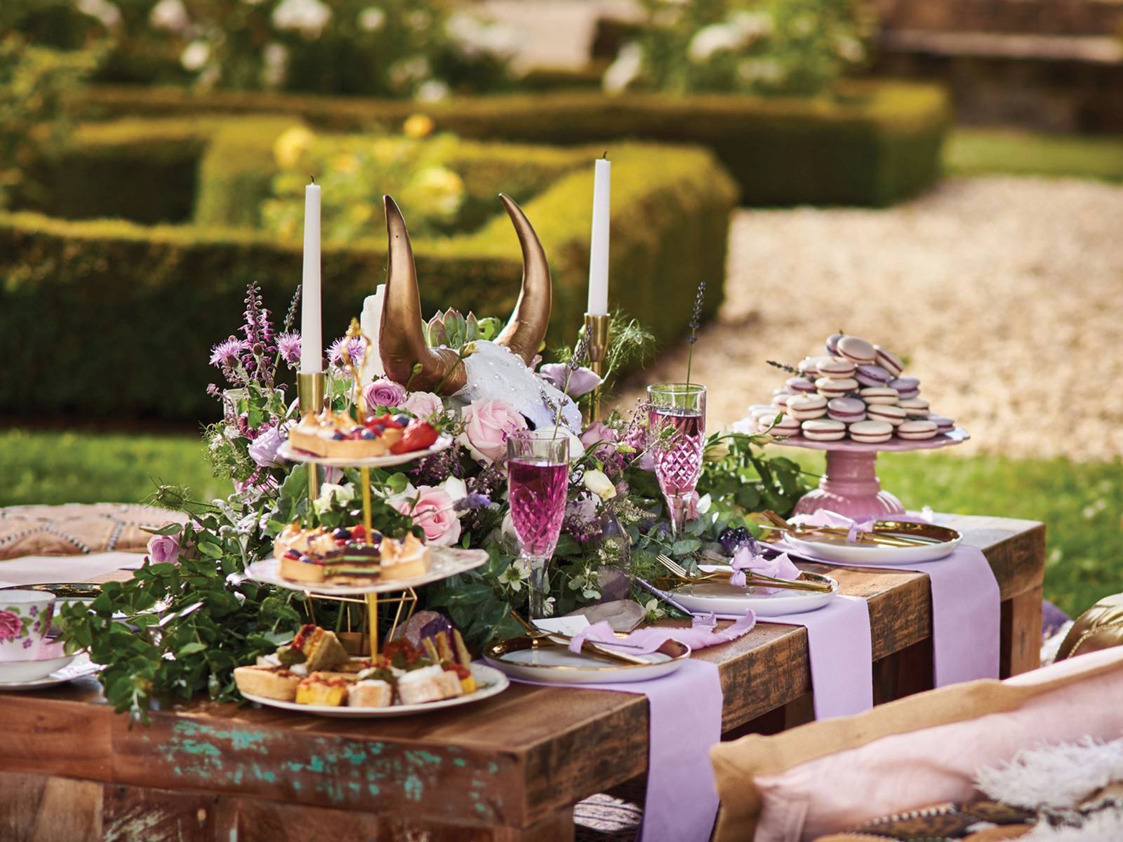 Rustic wood table with pink and lavender florals, dessert tower, china and crystal