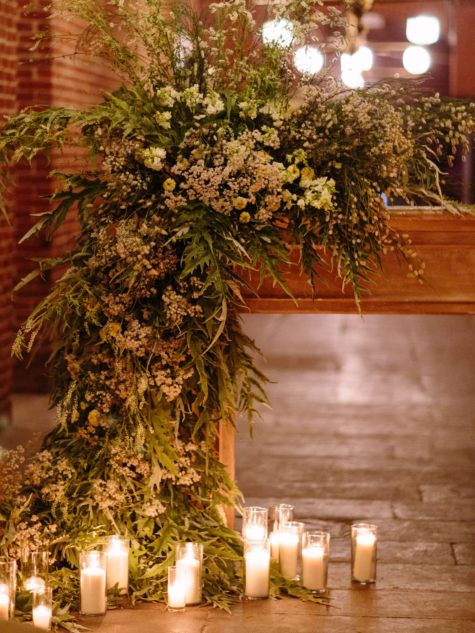 cascading ceremony alter arrangement with candlelight