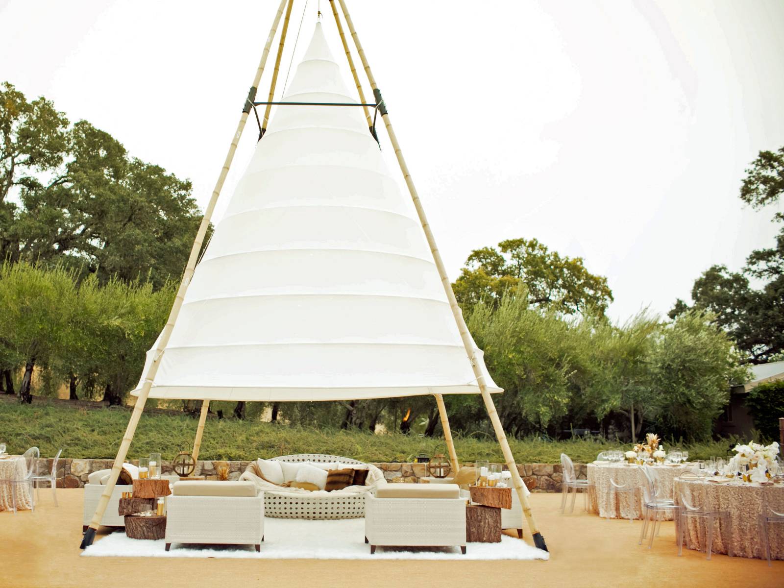 Lounge furniture under a giant white canvas Tepee