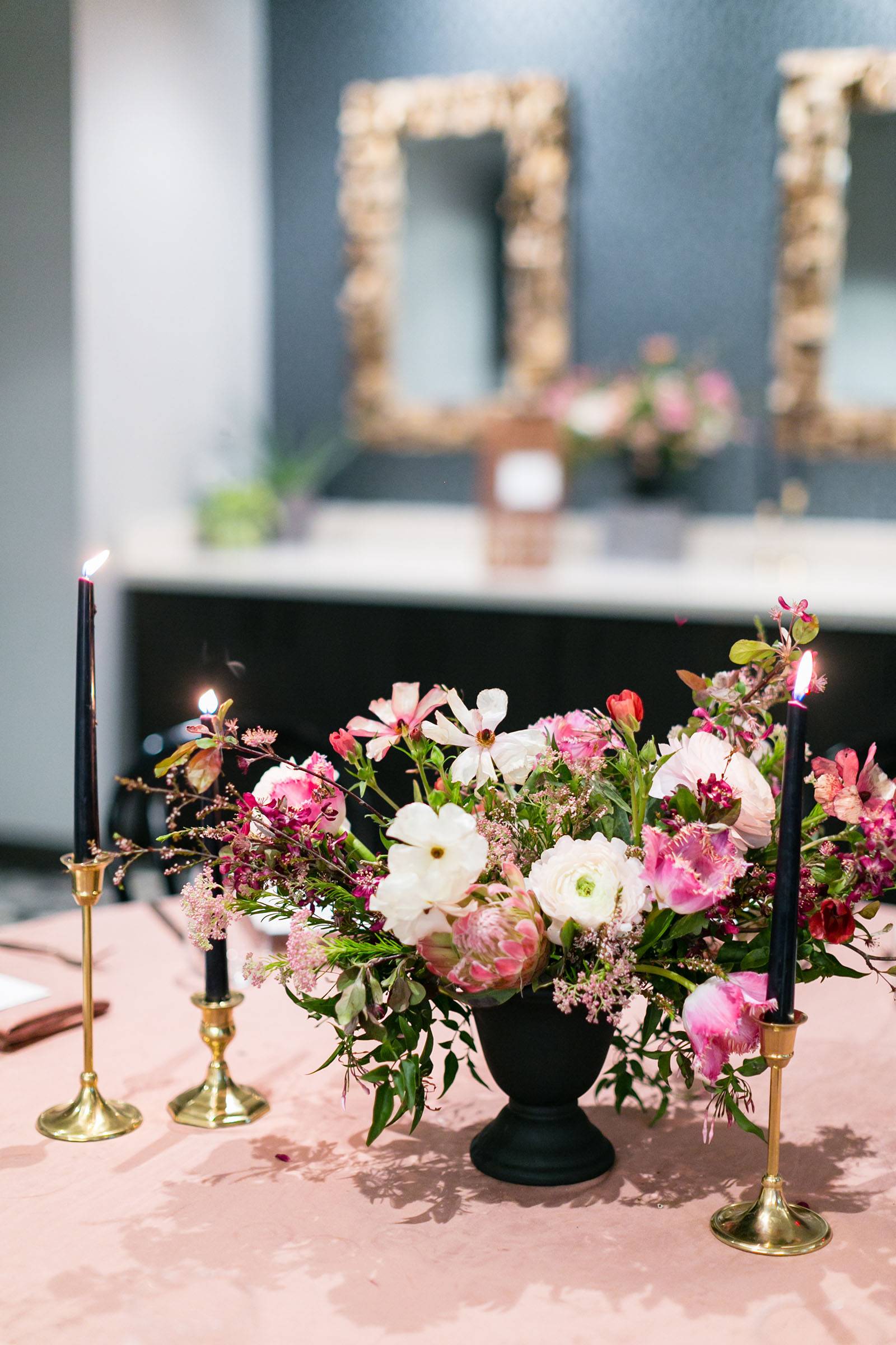 Pink, magenta and mauve centerpiece with black taper candles