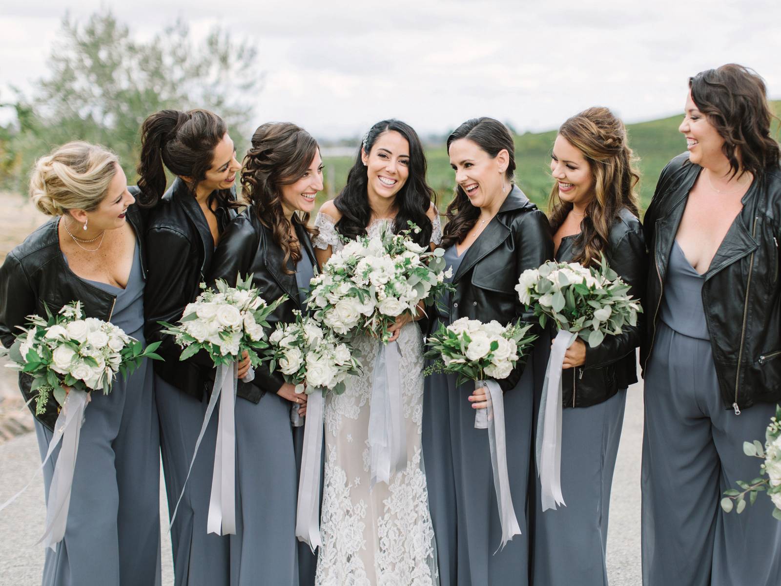 bridesmaids in silver dresses and black leather jackets