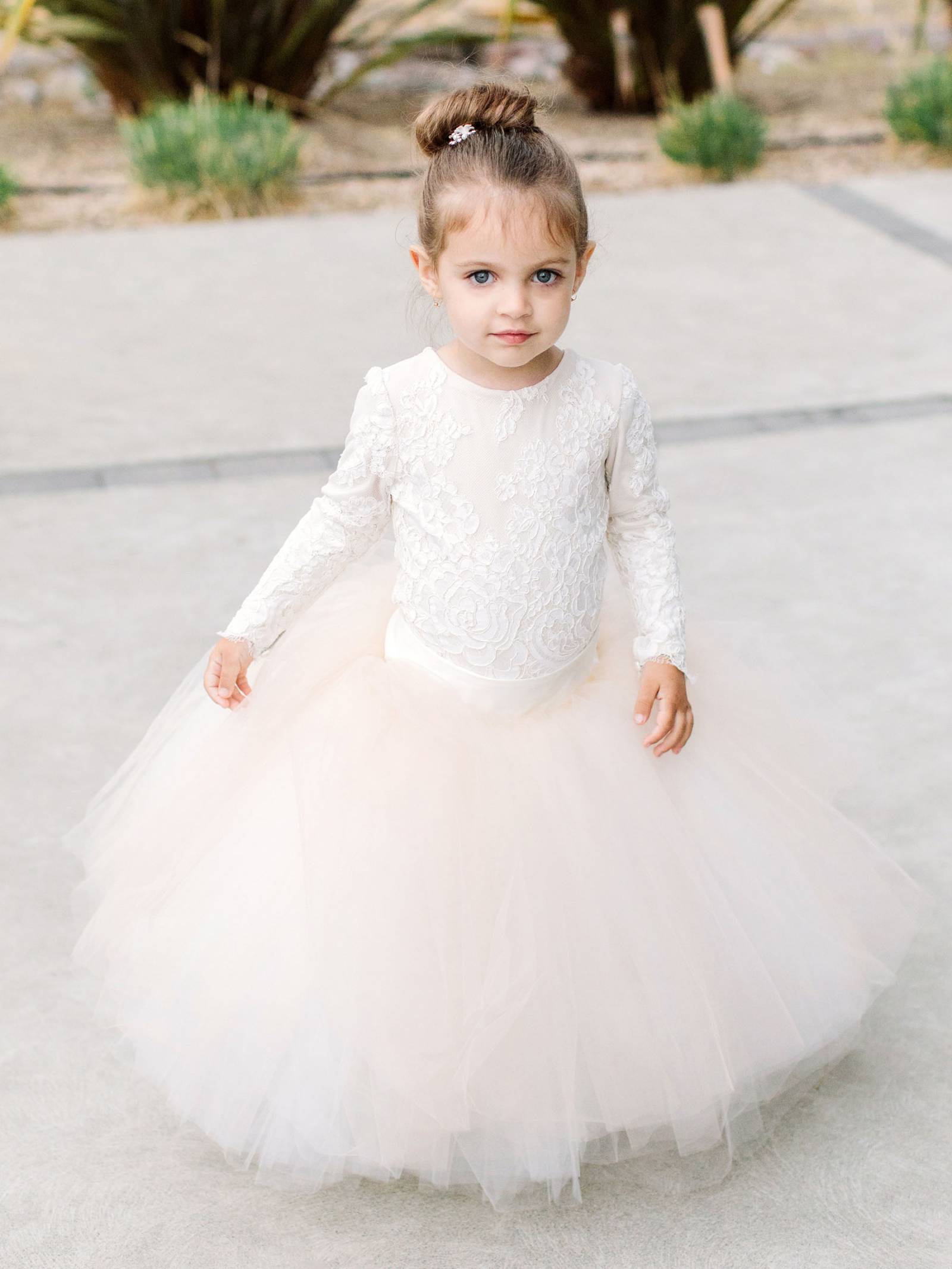 flower girl in white top and blush tutu