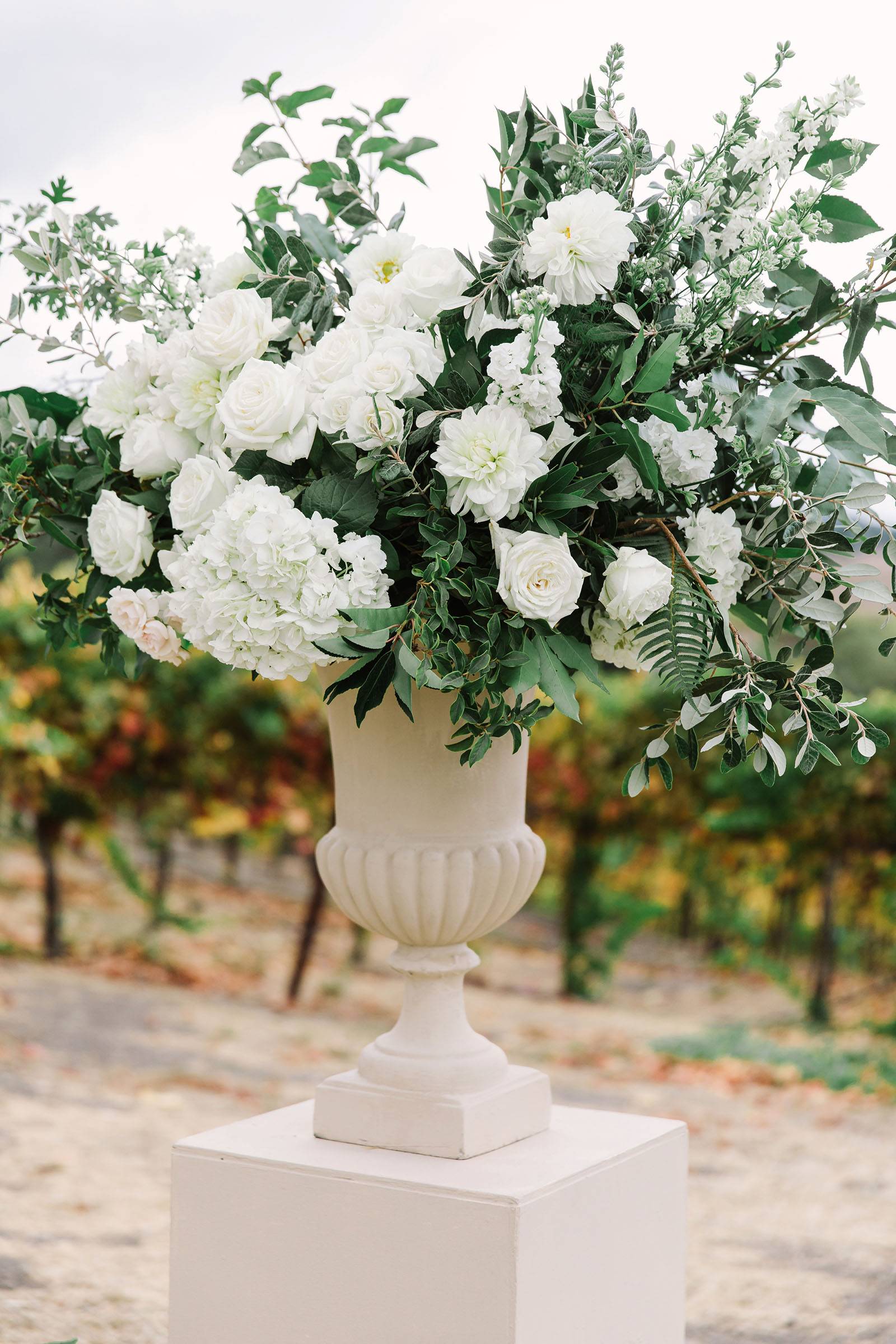 lush ceremony floral arrangement of white blooms and greenery