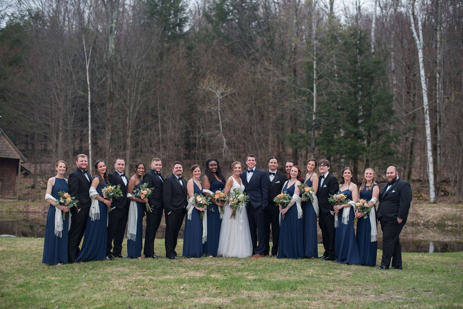 Wedding party with navy blue bridesmaid dresses on spring wedding day at Sleepy Hollow Inn in Vermon