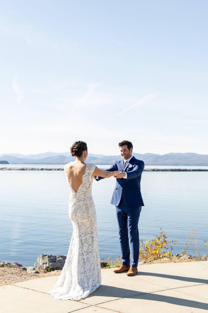 Bride and groom embrace after first look on Lake Champlain