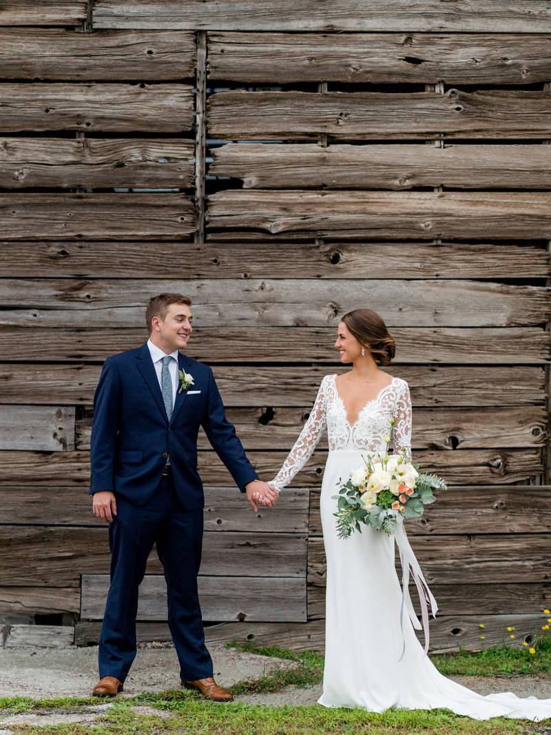 Bride and groom wedding day portrait at the Inn at the Round Barn Farm rustic backdrop photo