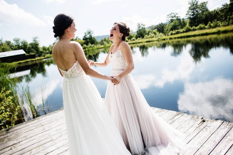 Two brides first look at The Ponds at Bolton Valley for summer Vermont Wedding captured by Happy Cou