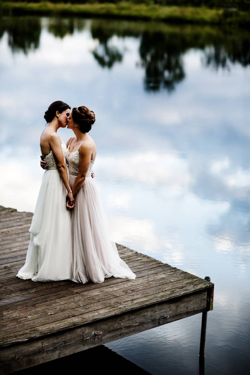 Two brides kissing after first look at The Ponds at Bolton Valley for summer Vermont Wedding capture
