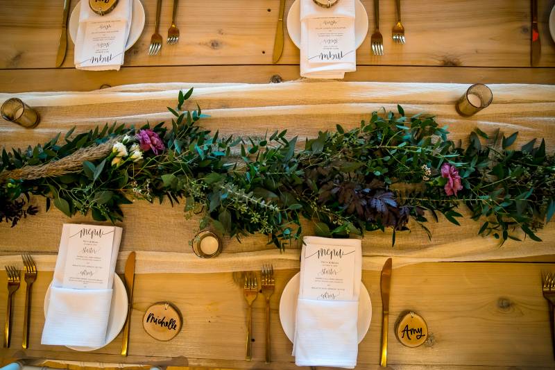 Greenery runner on rectangular tables during fall boho rustic wedding at Smuggler's Notch in Vermont