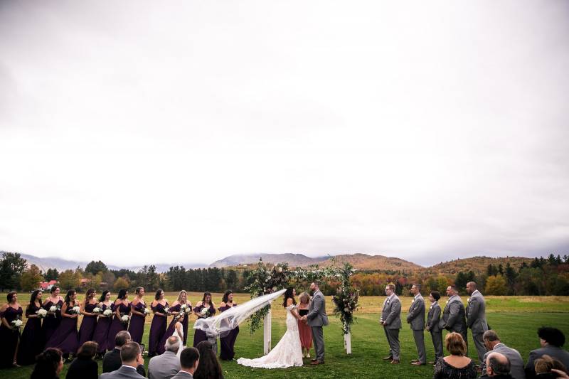Outdoor wedding ceremony during fall wedding at the Barn at Smugglers Notch in Vermont