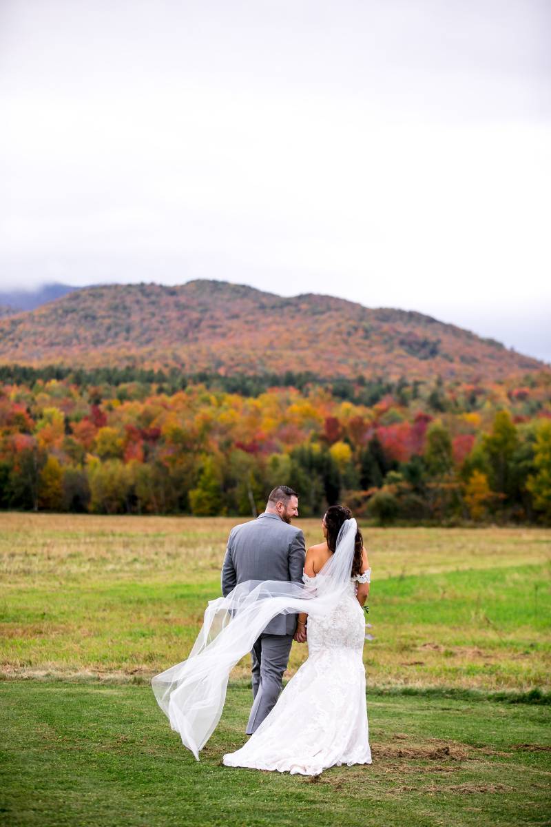 Wedding portrait of couple during peak foliage at fall wedding at the Barn at Smuggler's Notch in Ve