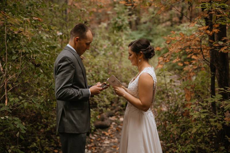 Couple reciting private vows in the woods on wedding day in Vermont