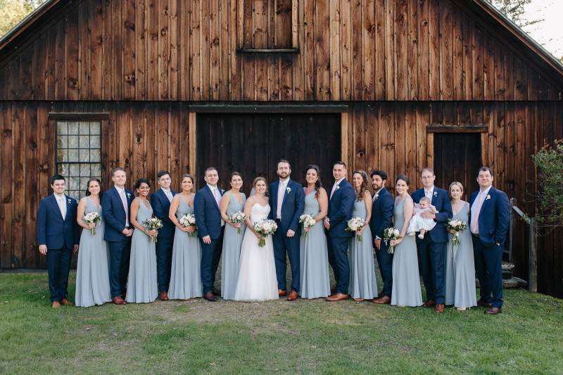 Dusty blue bridesmaid dresses and navy blue groomsmen suits during spring wedding at the Woodstock I