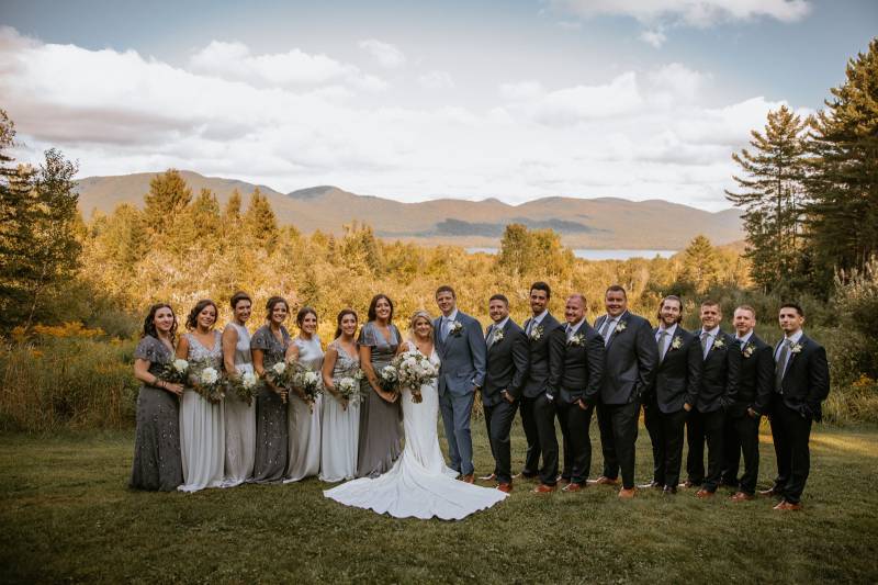 Grey bridesmaid dresses and grey groomsmen suits featured in wedding party portrait at the Mountain 