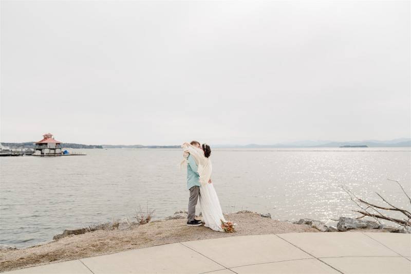 Couple kissing after lakefront Burlington elopement in March