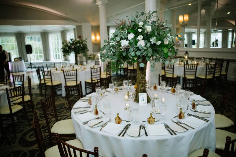 Elegant wedding reception at The Equinox with tall bouquets and maple syrup favors
