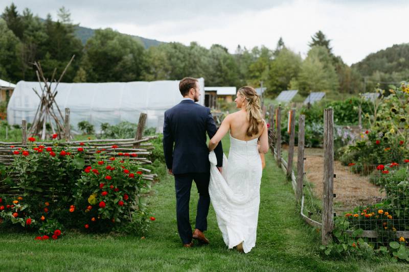 Bride and groom walking through farm at Lareau Farm Inn in Waitsfield Vermont