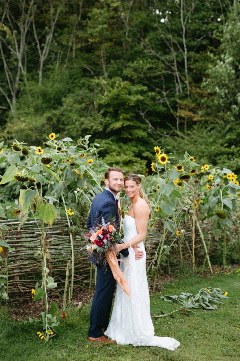 Bride and groom portrait in front of sunflowers
