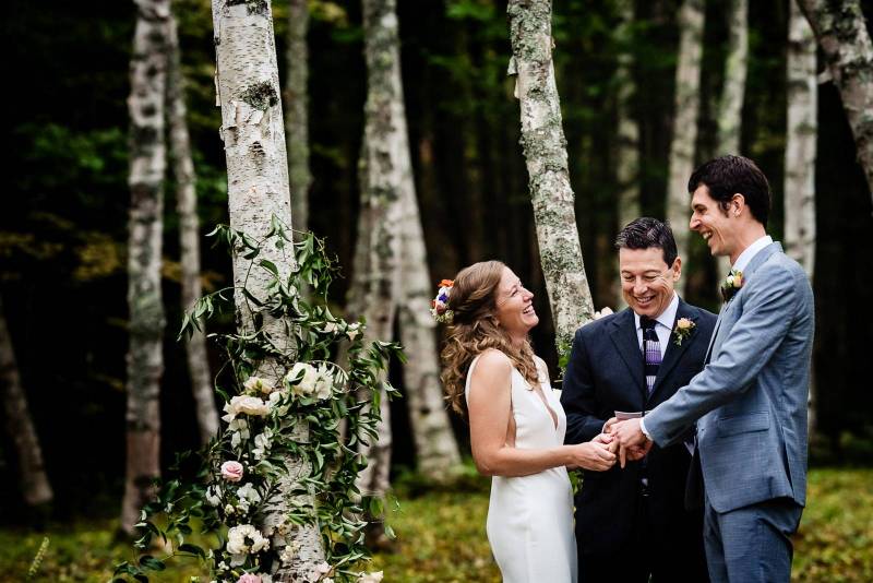 Bride and groom laughing during ceremony captured by Hannah Photography
