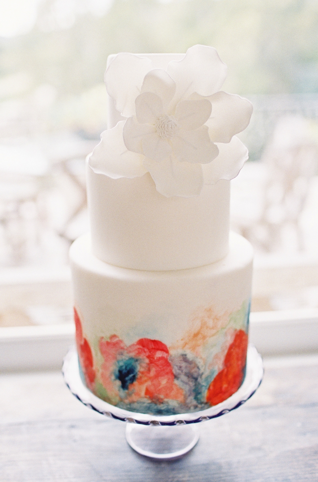 Colorful floral wedding cake in coral and turquoise